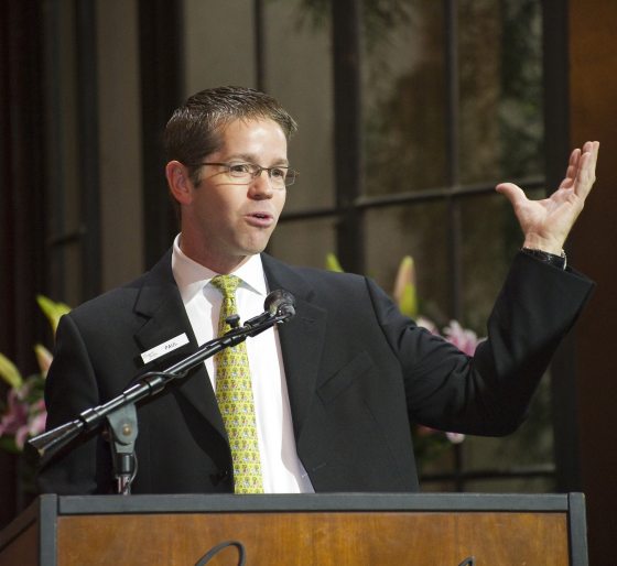 a person speaking at a podium 
